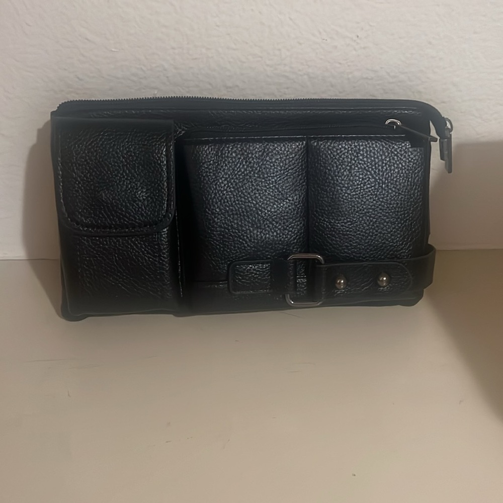 Brand new. Crossbody zippered adjustable strap bag.
